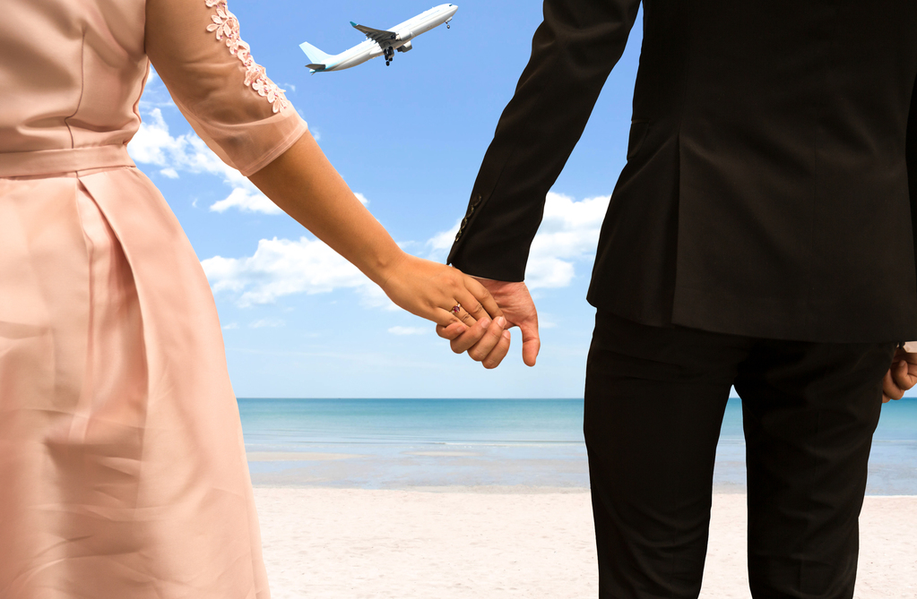 Bride and Groom holding hand on honeymoon in Island