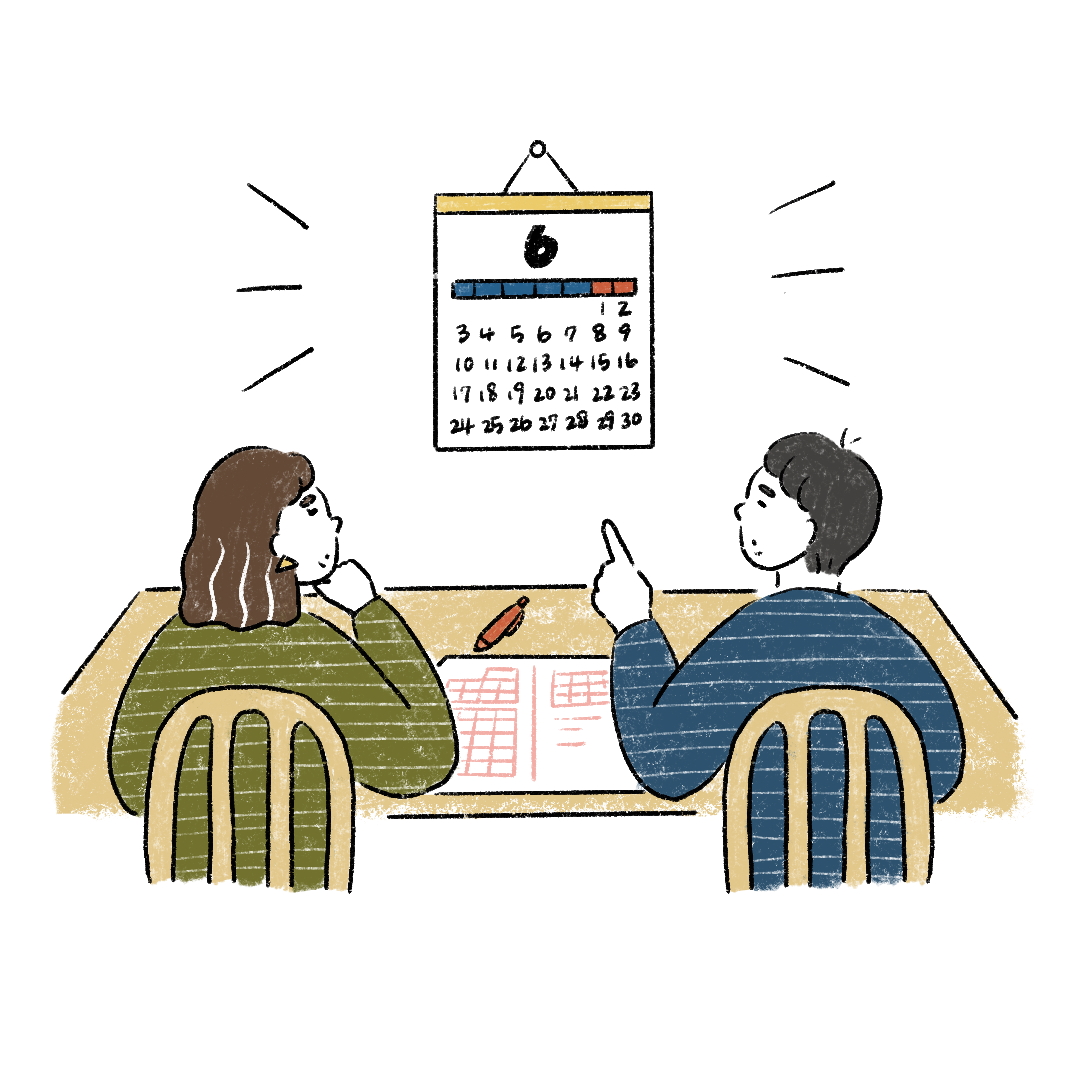 カレンダーを見て日取りを話し合うカップル